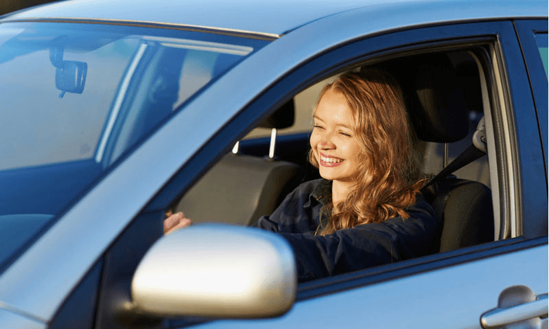 Teen learning to drive with professional instructor
